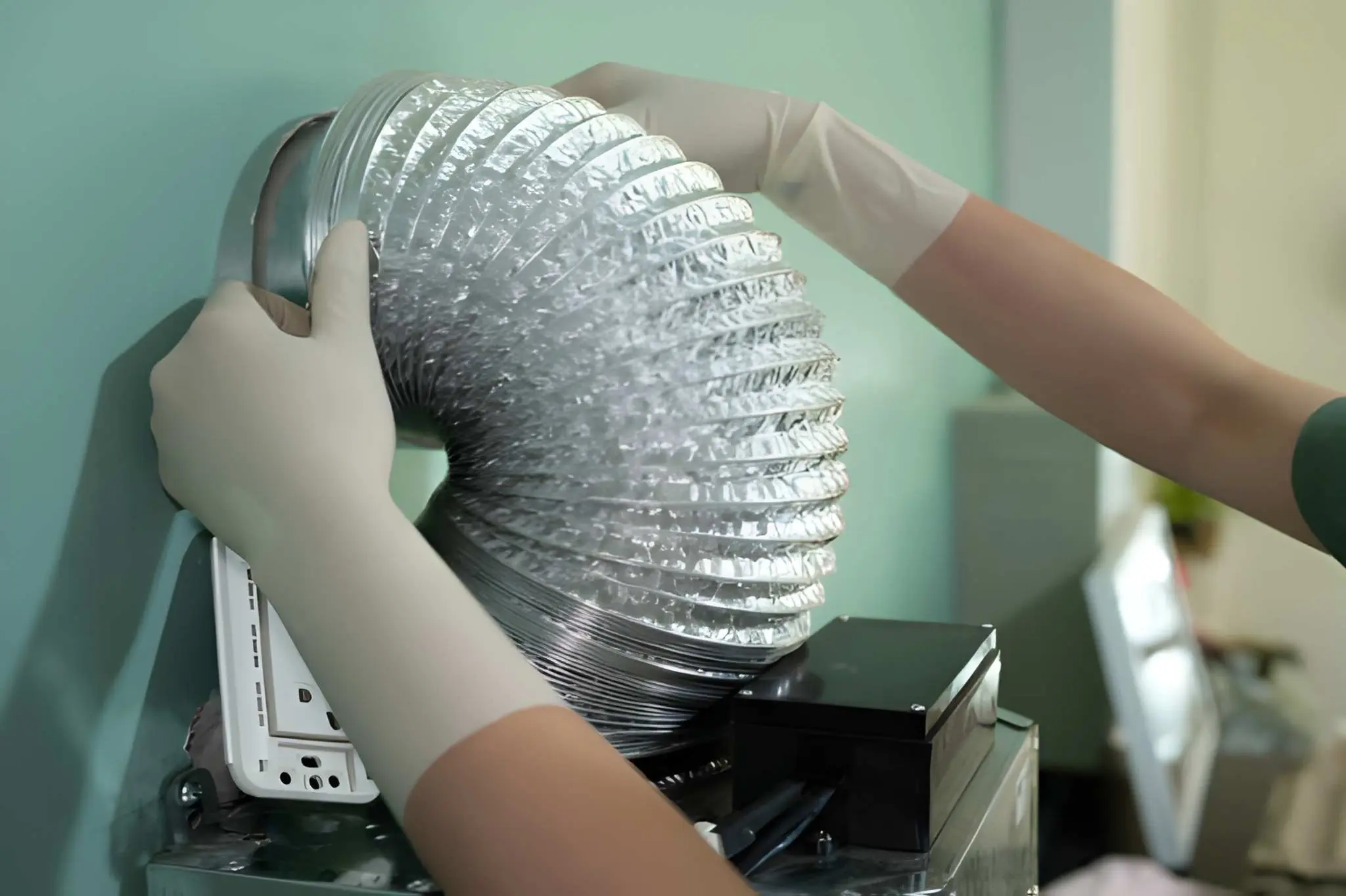 Technician installing a new dryer vent system to ensure safe ventilation and efficient dryer operation.