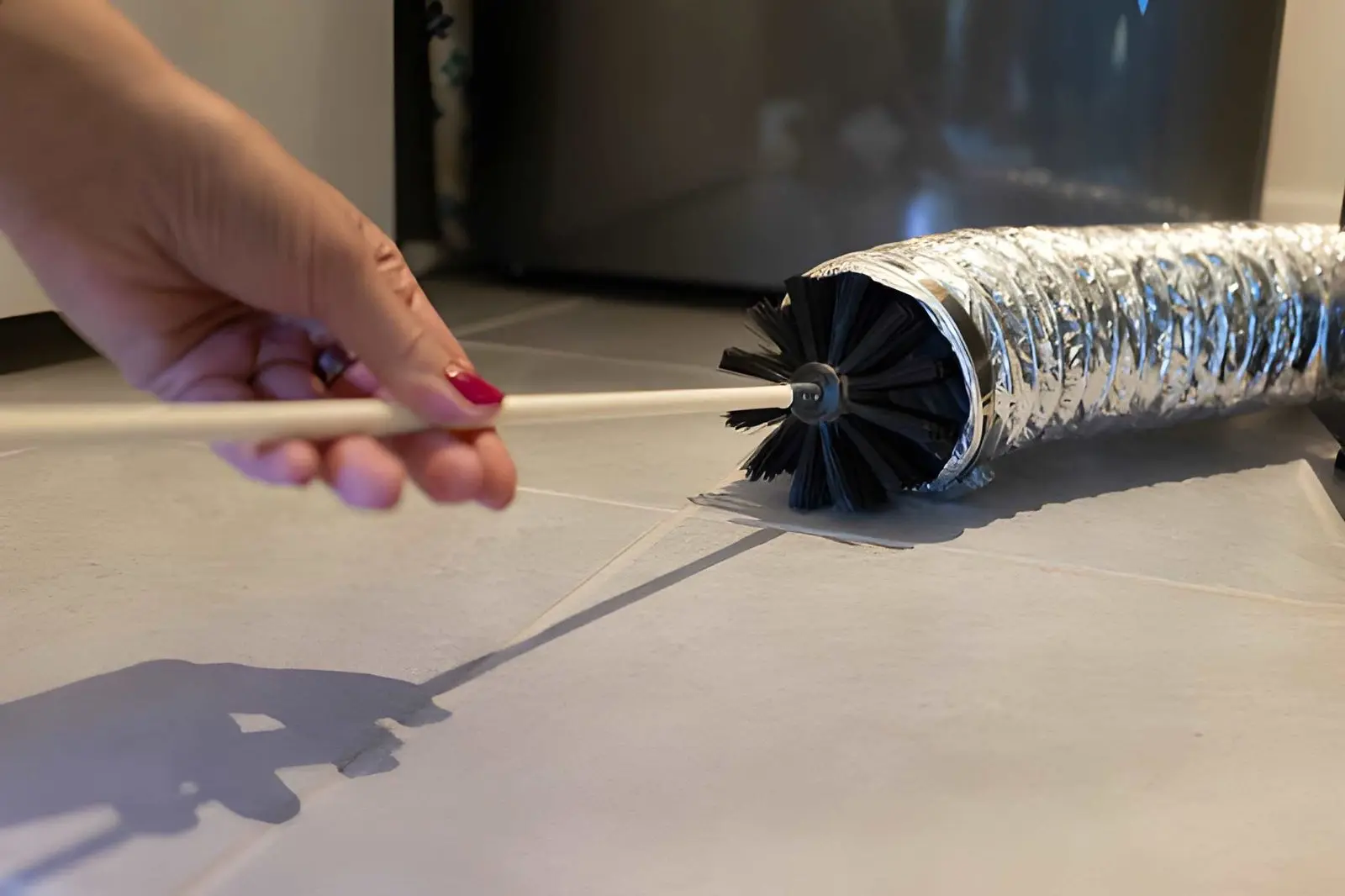 Technician performing Dryer Vent Cleaning in Manhattan Beach to remove lint and improve airflow